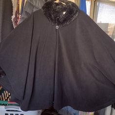 Black Poncho With Fur On The Sleeves And Neck, New Without Tags, Designed In A Large Or Extra Large Size, I Wear A Size 2 Extra Large, And It Fits Me Very Well, So It Is Very Roomy, Material? Flannel Fluffed Up Oversized Black Poncho For Cold Weather, Black Batwing Sleeve Cape For Fall, One Size Black Poncho For Cold Weather, Black Cape For Cold Weather In Fall, Casual Black Cape Poncho, Casual Black Cape-style Poncho, One Size Black Cape For Winter, Casual Black Poncho Cape, Black Poncho Cape For Cold Weather