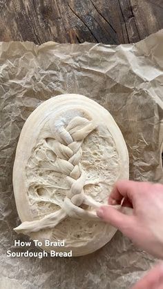 someone is making some bread on top of wax paper with the words how to braid sourdough bread