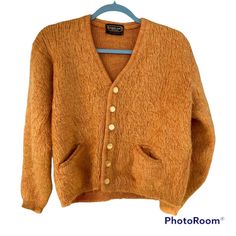 "Large Rare GOLD Orange Vintage 60s DRUMMOND \"Shaggy Man\" MOHAIR Cardigan SWEATER. Rare vintage 60's \"Shaggy Man\"  mohair cardigan by Drummond. It is in great condition. No rips, no mothing, no soiling, no smell. One small hole on the left sleeve. The fuzzy hairs of the sweater do a good job at masking the imperfection. Fuzzy hairy texture made with all natural fibers 65% mohair 35% virgin wool. Rib knot cuffs and twin inset pockets. Beautiful \"abalone look\" buttons. The color of this sweater when photographed shifts tones depending on the light. Please note this before purchasing. Color: Golden Orange with hints of rust red.  Size: Large (Vintage sizes runs smaller than modern sizes. Please note the measurements listed below.) Chest: Approx 20.5\" armpit to armpit Shoulders: Approx Tiny Tim, Mohair Cardigan, Gold Orange, Embroidery And Stitching, Orange Gold, Vintage 60s, Jumpers And Cardigans, Costume Design, Wool Sweaters