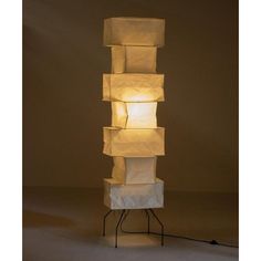 a lamp that is sitting on top of a stand with several cubes in it