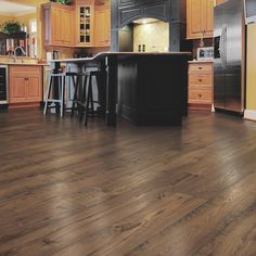 a kitchen with wooden floors and black appliances