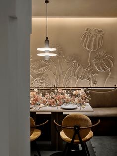 an elegant dining room with flowers on the wall