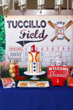 a table topped with a cake covered in frosting next to baseball memorabilia and candles