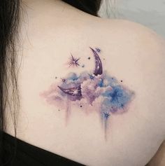 the back of a woman's shoulder is covered with watercolors and stars