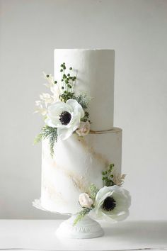 a white wedding cake with flowers on top