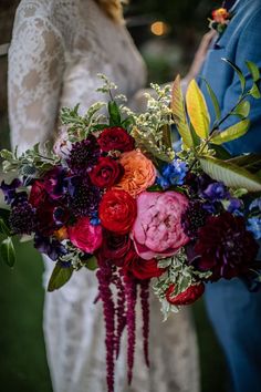 the bride and groom are holding their wedding bouquet