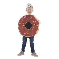 a young boy is holding a giant donut costume