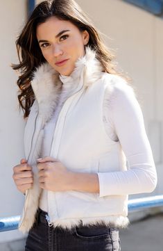 Soft and fluffy faux fur lends cozy comfort to a reversible vest equipped with handy pockets. Stand collar Lined 70% modacrylic, 30% acrylic faux fur with 100% polyester reverse Machine wash, line dry Imported Sleeveless Mink Outerwear With Faux Fur Lining, Casual White Faux Fur Coat, Mink Vest, Initial Birthstone Necklace, Charcuterie Gifts, Cozy Wrap, Fabulous Furs, Blue Candles, Reversible Vest