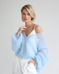 Embrace a soft and serene look with this beautiful light blue knit sweater, ideal for cooler Fourth of July evenings or a casual daytime event. The sweater features a delicate texture and oversized buttons, paired with crisp white trousers for a fresh, airy feel.   Photo credit by: @likeangel_brand