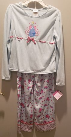 DISNEY CINDERELLA SLEEPWEAR PAJAMAS SET!THIS IS NEW WITH TAGS. A SUPER CUTE SET OF PAJAMAS THAT HAVE A PRETTY BLUE TOP WITH RIBBON ACCENT AND A GLITTERY PRINT OF CINDERELLA ON FRONT. THE LOUNGE PANTS ARE A SILKY SOFT MATERIAL AND HAVE CASTLES AND CINDERELLA GLASS SLIPPER PRINT ALL OVER. THIS IS A GIRLS SIZE 10-12. GREAT FOR ANY FAN! THINK GREAT GIFT! SHIPPING IS A FLAT RATE OF $8.95. Sorry, I do not accept refunds and request you do not purchase item from me if you intend to return it. I provide Cute Long Sleeve Lounging Set, Cute Long Sleeve Loungewear Sets, Cute Long Sleeve Bedtime Sets, Spring Long Sleeve Sleepover Set, Cotton Coming Home Outfit Set With Long Sleeves, Cotton Long Sleeve Coming Home Outfit Set, Cute Blue Long Sleeve Sleepwear, Cinderella Glass Slipper, Pajamas Long Sleeve