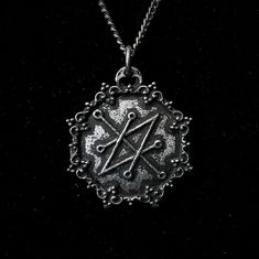 The Azazel Seal Pendant with Gothic Frame is a handcrafted piece made from fine pewter, containing 98% tin, featuring a detailed design that showcases the Seal of Azazel. This pendant measures 2.5 cm in diameter and is available with a choice of a stainless steel chain in either 18 or 24 inches, ensuring durability and hypoallergenic properties. With an antique finish, this pendant presents a textured appearance that gives it the look of an ancient artifact, enhancing its character and significa Symbolic Metal Necklaces With Antique Finish, Silver Gothic Necklace With Antique Finish, Gothic Silver Necklaces With Antique Finish, Silver Gothic Necklaces With Antique Finish, Adjustable Silver Necklace With Antique Finish, Handmade Pewter Necklaces In Silver, Spiritual Engraved Pewter Necklace, Silver Symbolic Pewter Necklace, Silver Symbolic Pewter Necklaces