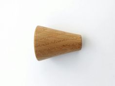 a close up of a wooden knob on a white surface