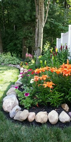 a garden with rocks and flowers in it