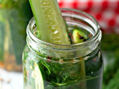 a pickle in a mason jar with cucumbers