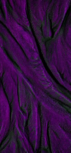 an abstract purple background with black lines and curves in the shape of wavy fabric or cloth