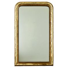 a gold framed mirror on a white background