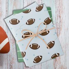 wrapping paper with footballs on it and a football ball tied to the side of it