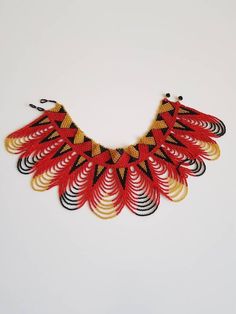 This shoulder necklace is made using colorful fine beads. Perfect for weddings, African themed events, cultural events etc. Makes a perfect gift too. **Buy multiple items and pay shipping for 1 item only.The rest ships free. More neckleces here; https://www.etsy.com/shop/TribalTess?ref=seller-platform-mcnav&section_id=21306083 Back to my shop; https://www.etsy.com/shop/TribalTess?ref=seller-platform-mcnav Traditional Colorful Beaded Necklaces For Celebrations, Traditional Beaded Necklaces For Celebrations With Colorful Beads, Multicolor Beaded Choker For Wedding, Traditional Tiny Beads Choker Necklace, Handmade Red Beaded Necklaces For Celebration, Traditional Colorful Bead Choker, Traditional Large Beads Choker Necklace, Traditional Large Beaded Choker Necklace, Unique Beaded Necklaces For Festivals Gift