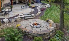 an outdoor patio with fire pit and seating area