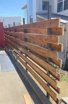 a wooden fence in front of a building