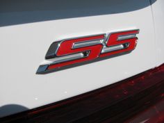 the rear end of a white car with red letters that say g5 on it