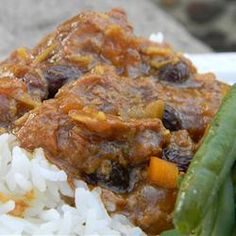 a white plate topped with rice and green beans