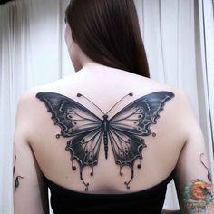 a woman with a butterfly tattoo on her back