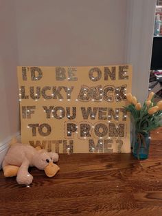 a teddy bear sitting next to a sign that says i'd be one lucky angel if you went to prom with me