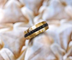 a wedding band with black diamonds on it