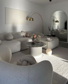 a living room filled with lots of white furniture