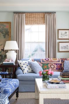 a living room filled with blue couches and chairs