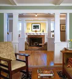 a living room filled with furniture and a fire place in the middle of a room