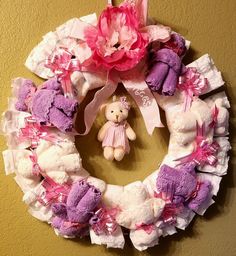 a wreath with teddy bears and a pink flower