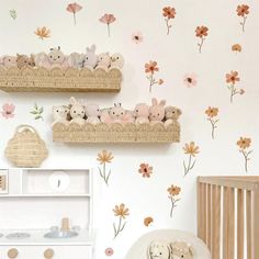 a baby's room with flowers and teddy bears on the wall