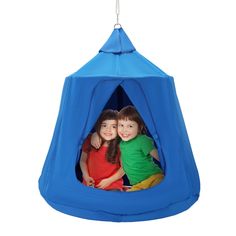 two children in a blue tent hanging from a white hook on the ceiling, with their arms around each other