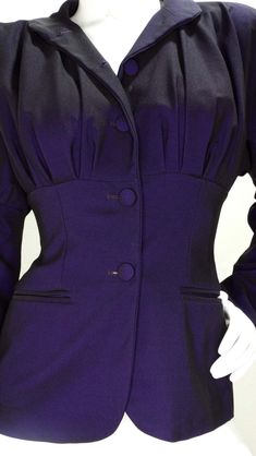 For Sale on 1stDibs - Circa late 1980s, this stunning Romeo Gigli Victorian style blazer features a beautiful deep iridescent purple color and large leg-o-mutton sleeves. Pleating