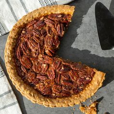 a pecan pie with one slice missing from it