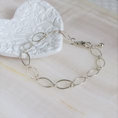 "* Sterling Silver Long Loop Layering Bracelet * * Beautiful sterling silver long loop layering bracelet finished with a sterling silver lobster claw clasp and completed with sterling silver bead. This bracelet 7\" long and is created with 925 sterling silver material and not made with plated materials. * Heart Clay Dish (also sold separately) https://www.etsy.com/listing/1094093610/heart-ring-dish-boho-ring-dish-christmas * This bracelet will arrive in a box tied with a ribbon perfect for gift Sterling Silver Bracelet With Delicate Chain For Everyday, Delicate Chain Sterling Silver Bracelet For Everyday, Everyday Sterling Silver Bracelet With Delicate Chain, Sterling Silver Oval Link Bracelet With Adjustable Chain, Minimalist Sterling Silver Oval Link Bracelet With Adjustable Chain, Sterling Silver Bracelet With Delicate Chain, Silver Link Bracelet With Delicate Chain, Delicate Sterling Silver Bracelets In Silver Color, Delicate Sterling Silver Adjustable Chain Bracelet