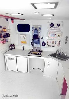 a white kitchen with lots of appliances and counters