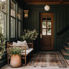 the front porch is decorated with plants and potted plants