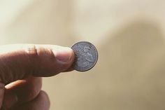 a person holding a coin in their left hand