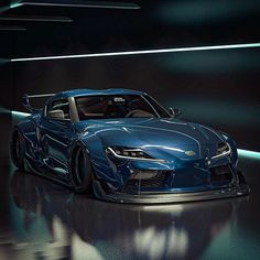 a blue sports car parked in a dark room