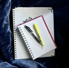 a notepad and pen on top of a notebook