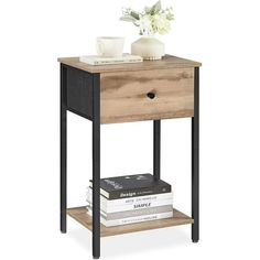 an end table with books and a vase on top