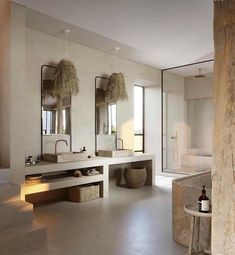 a large bathroom with two sinks and mirrors