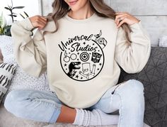 If you can't find what you're looking for in my listings, please feel free to send me a message.  🛍️🛍️🛍️How to place an order🛍️🛍️🛍️ Select your desired sweatshirt or hoodie size. Choose the color for your sweatshirt or hoodie. Pick a design color if applicable. For personalized designs, enter your customization in the "Add your personalization" field. Choose the quantity you'd like to order. Click "ADD TO CART." If you want additional items (to save on shipping costs), return to our shop and repeat the above steps. 👕 SIDES SEAMED: Our garments are carefully crafted with sideseams. 🪡 🎽 SHOULDER TAPING: High-quality shoulder taping for added durability. 🏋️ 💪 FITTED AT BICEP: Designed for a snug fit around the bicep. 💼 🛒 RETAIL FIT: Enjoy a comfortable retail fit. 🛍️ 🚻 UNISEX S Universal Sweatshirt, Universal Vacation, Magical Castle, Universal Studio, Design Color, Shoulder Taping, Wizard, Snug Fit, Color Design