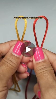 two hands holding scissors with pink and gold designs on them, one being held by the other