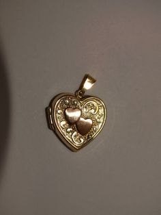 The heart pendant is made with 10k yellow Gold featuring a Double Heart Locket. Size 20 x 18mm with 2.3 grams. 14k Stamped Double Heart Jewelry For Valentine's Day, Gold Double Heart Keepsake Jewelry, Valentine's Day 14k Stamped Double Heart Jewelry, 14k Gold Heart-shaped Locket, 14k Gold Heart Locket Jewelry, Heart-shaped 14k Gold Locket, 14k Gold Heart Pendant Locket, Yellow Gold Double Heart Locket Jewelry, Gold Double Heart Locket Jewelry