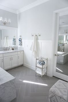 a bathroom with marble floors and white walls