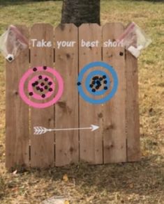 a wooden fence with two arrows painted on it